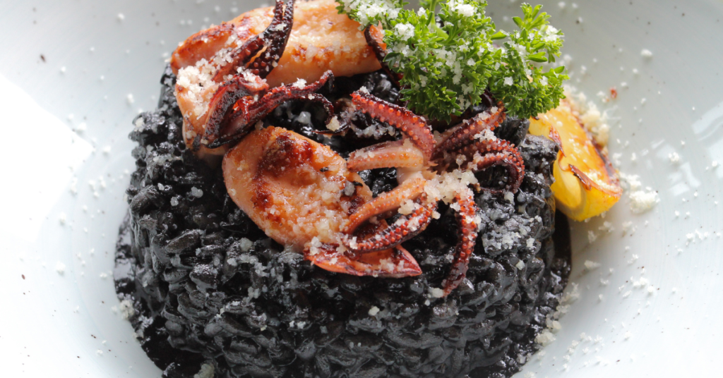 Black Rice with Seafood: A vibrant seafood dish featuring black rice as the base, accompanied by a variety of seafood such as shrimp, mussels, and scallops.