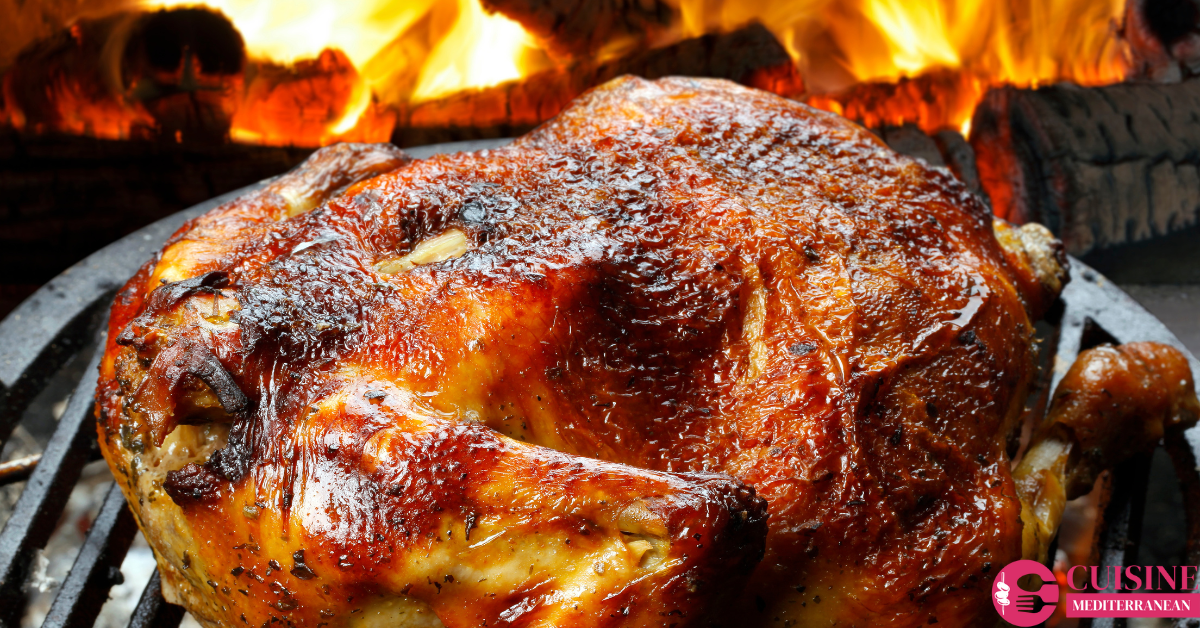 A beautifully roasted whole chicken on a platter, garnished with fresh herbs.
