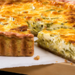 Mediterranean quiche dish filled with spinach, feta cheese, and olives.
